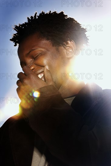 Black man laughing outdoors