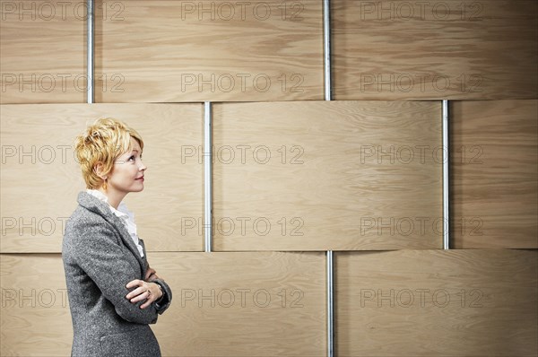 Caucasian businesswoman standing with arms crossed