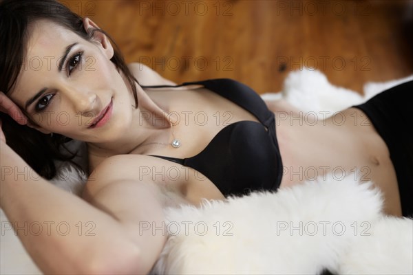 Caucasian woman in lingerie on shag rug
