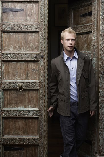 Caucasian man standing in ornate doorway