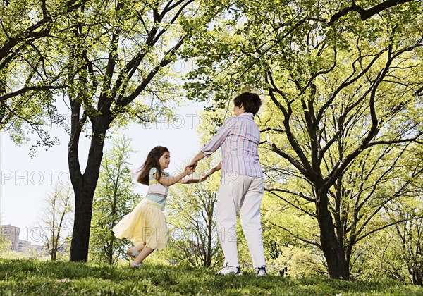 Senior Caucasian woman and granddaughter playing in park