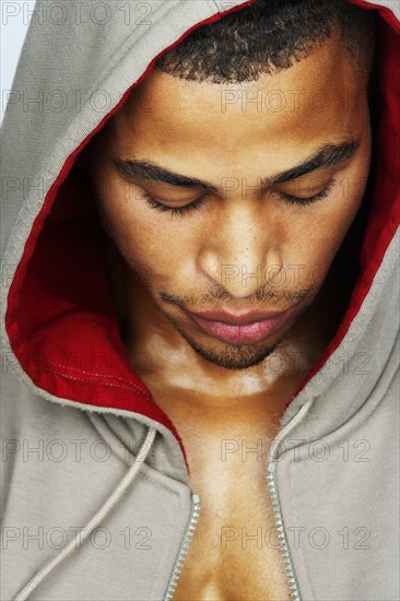 Mixed race man wearing hoody