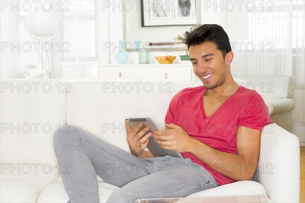 Mixed race teenager using digital tablet