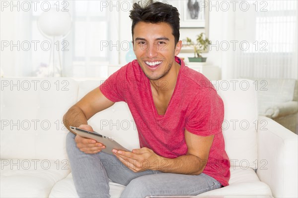 Mixed race teenager using digital tablet