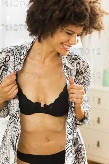Mixed race woman getting dressed
