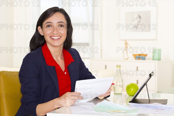 Mixed race businesswoman working at desk