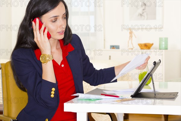 Mixed race businesswoman working at desk