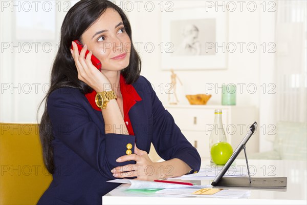 Mixed race businesswoman working at desk