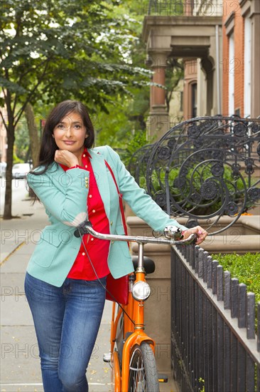 Mixed race woman with bicycle