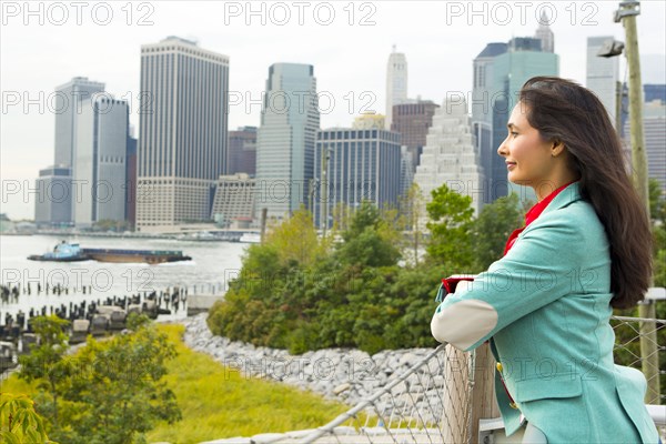 Mixed race woman overlooking park and river