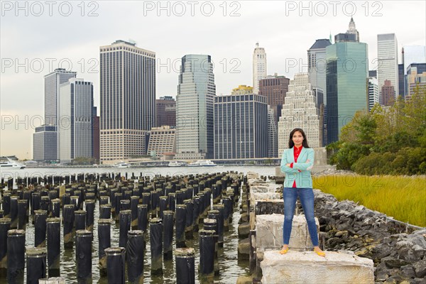 Mixed race woman smiling at urban waterfront