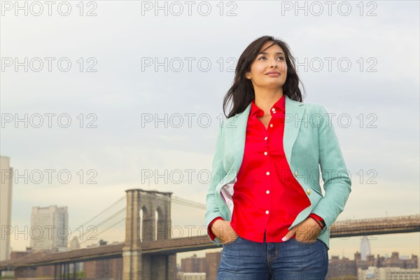 Mixed race woman and city skyline