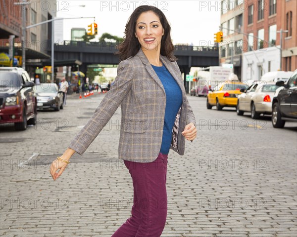 Mixed race woman crossing city street