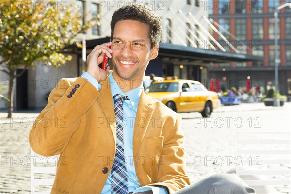 Mixed race businessman talking on cell phone