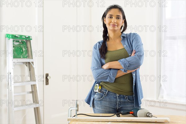 Mixed race contractor working in shop