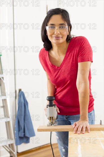 Mixed race woman using jigsaw
