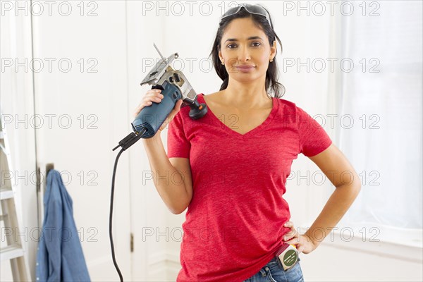 Mixed race woman holding jigsaw