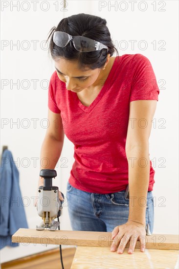 Mixed race woman using jigsaw