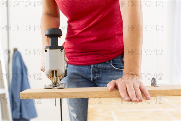 Mixed race woman using jigsaw