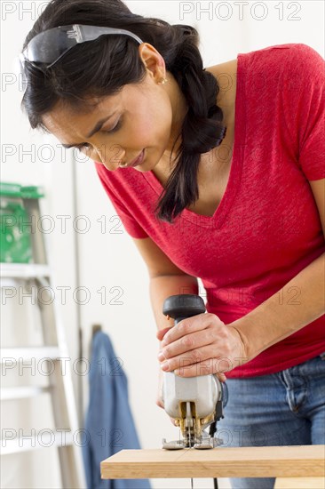 Mixed race woman using jigsaw