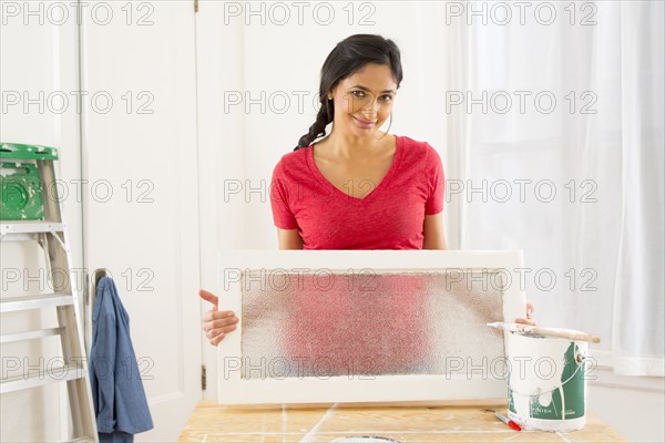 Mixed race woman making window pane