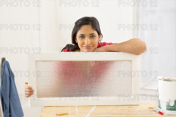 Mixed race woman making window pane