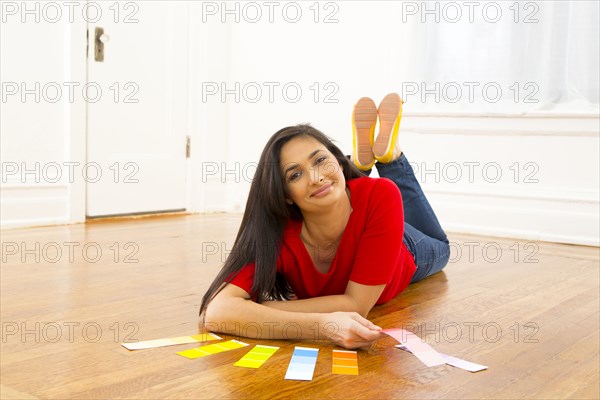 Mixed race woman examining paint swatches