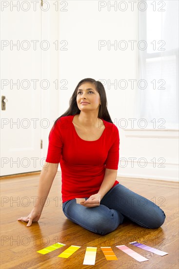 Mixed race woman examining paint swatches