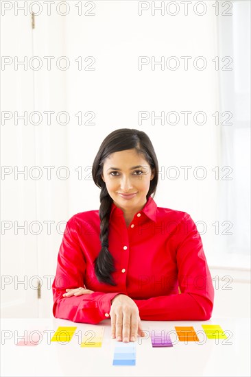 Mixed race woman examining paint swatches