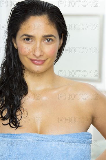 Mixed race woman wrapped in towel