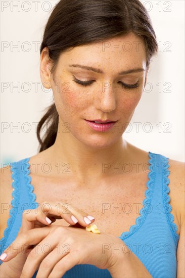 Caucasian woman applying lotion