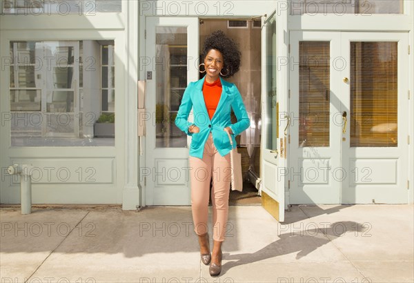 Mixed race woman standing on city sidewalk