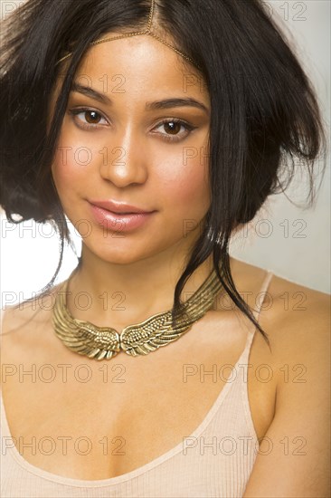 Hispanic woman wearing gold necklace