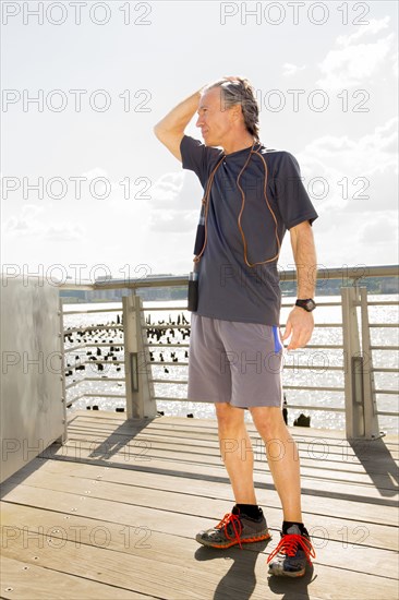 Caucasian man standing on wooden deck