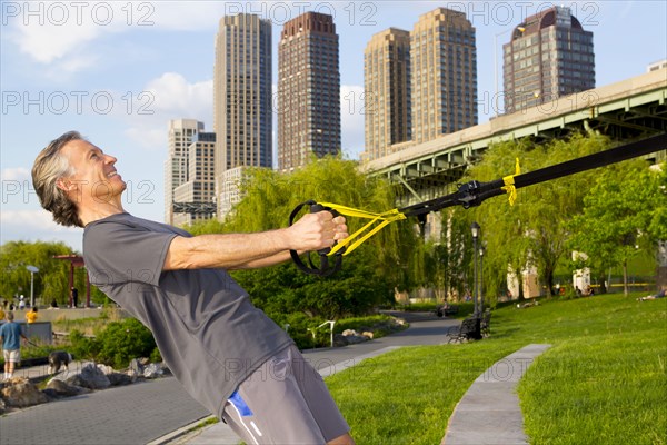 Caucasian man exercising in urban park