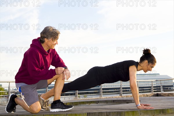 Couple exercising in waterfront park