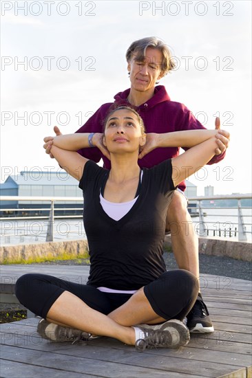 Couple exercising in waterfront park