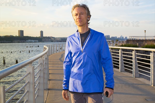 Caucasian man standing at urban waterfront