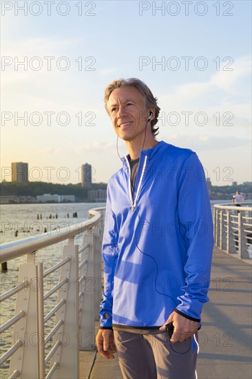 Caucasian man standing at urban waterfront