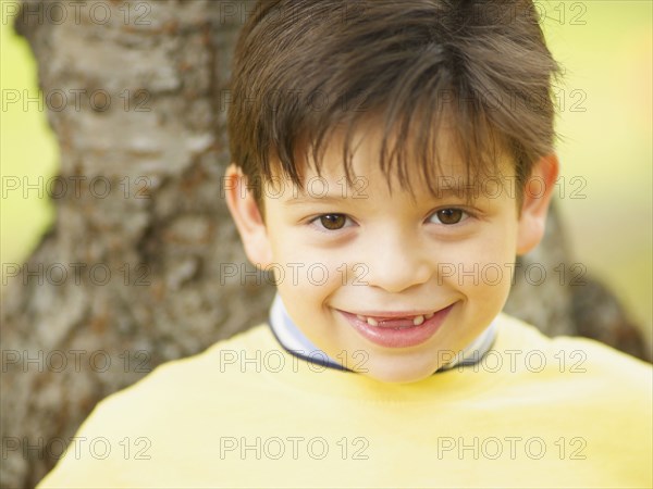 Toothless Hispanic boy smiling