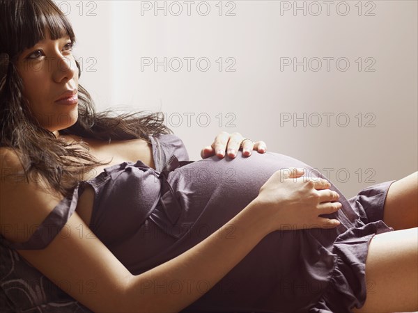 Pregnant mixed race woman relaxing