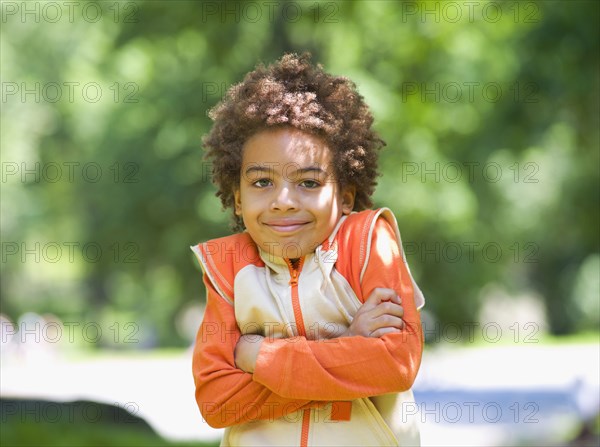 Mixed race outdoors with arms crossed