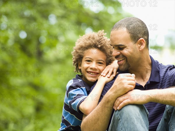 Father and son smiling outdoors