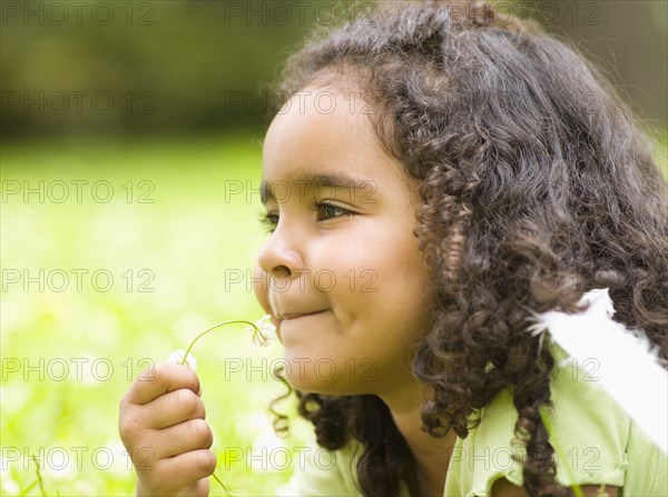 Mixed race girl laying in grass