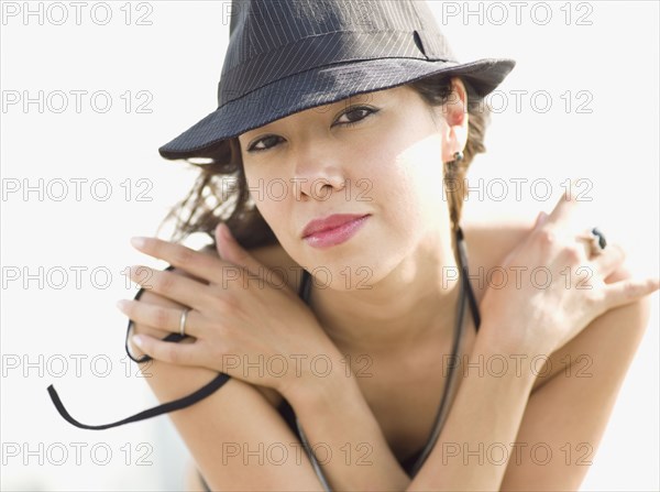 Mixed race woman wearing hat