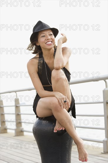 Mixed race woman sitting on pier