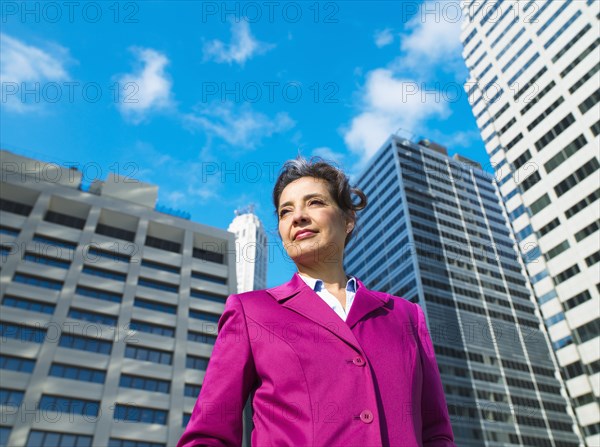 Caucasian Businesswoman standing in city