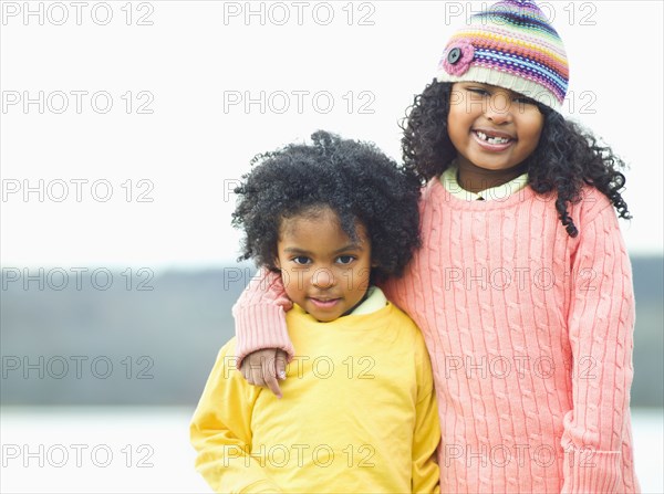 Mixed race children posing outdoors