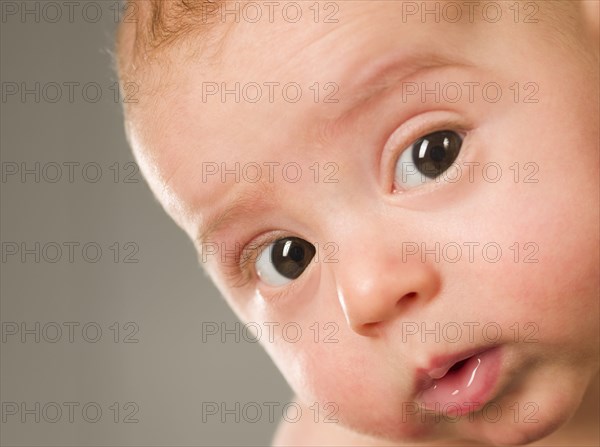 Curious mixed race newborn baby