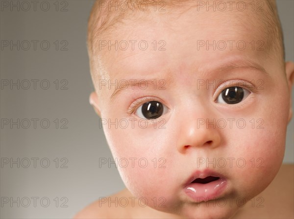 Curious mixed race newborn baby